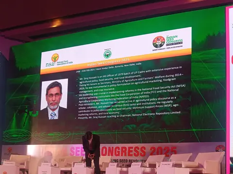 Siraj Hussain addressing the Seed Congress 2025, shown on the stage screen