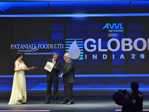 Siraj Hussain presenting an award on stage at Globoil India 2025